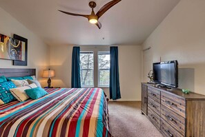 A bedroom with a bed, a dresser, a television, and a ceiling fan. - Mountain-View Rooftop Deck: Sedona Hideaway (Sedona)
