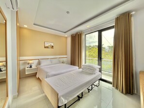 Deluxe Triple Room, Balcony | Minibar, desk, iron/ironing board, free WiFi