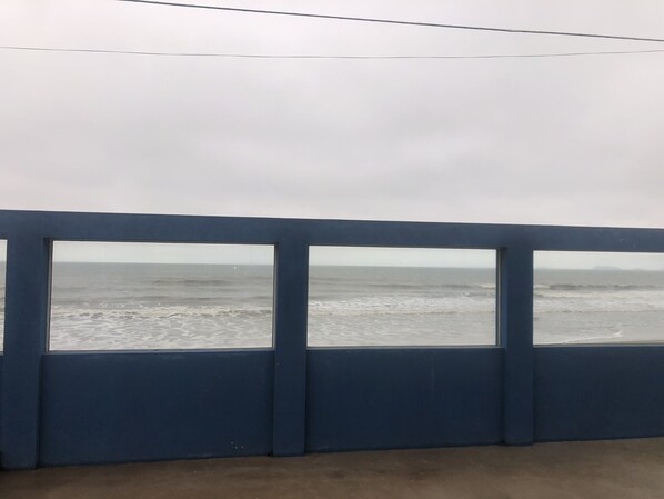 Enjoy the serene view of the ocean from this balcony.
