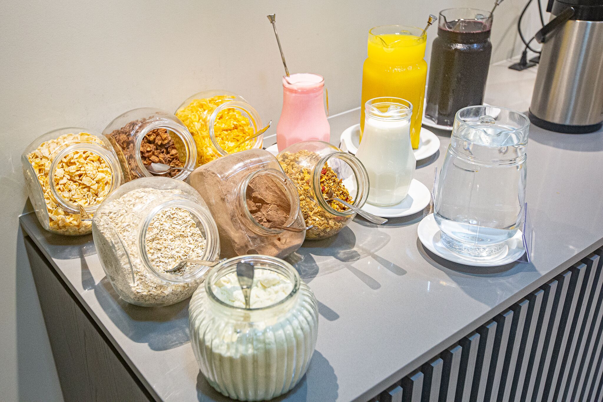 A breakfast buffet with various food items and beverages.