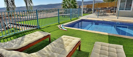 2 outdoor pools, a heated pool, pool umbrellas, pool loungers