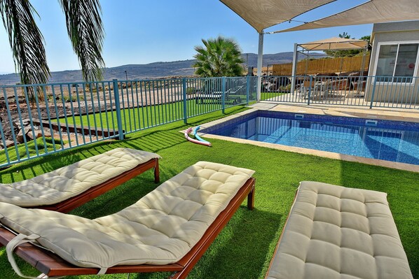 2 outdoor pools, a heated pool, pool umbrellas, pool loungers
