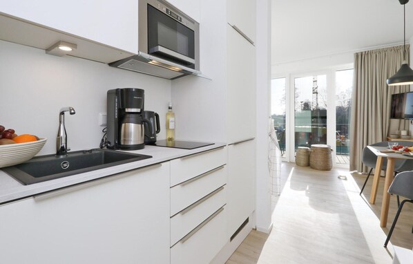 Fridge, stovetop, dishwasher, coffee/tea maker