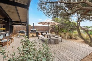 An outdoor patio with a grill, seating, and a pergola. - Barefoot in Blairgowrie (Blairgowrie)