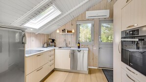 A modern kitchen with a central island, stainless steel appliances, and a skylight. - Amazing home in ålbæk with WiFi (Ålbæk)