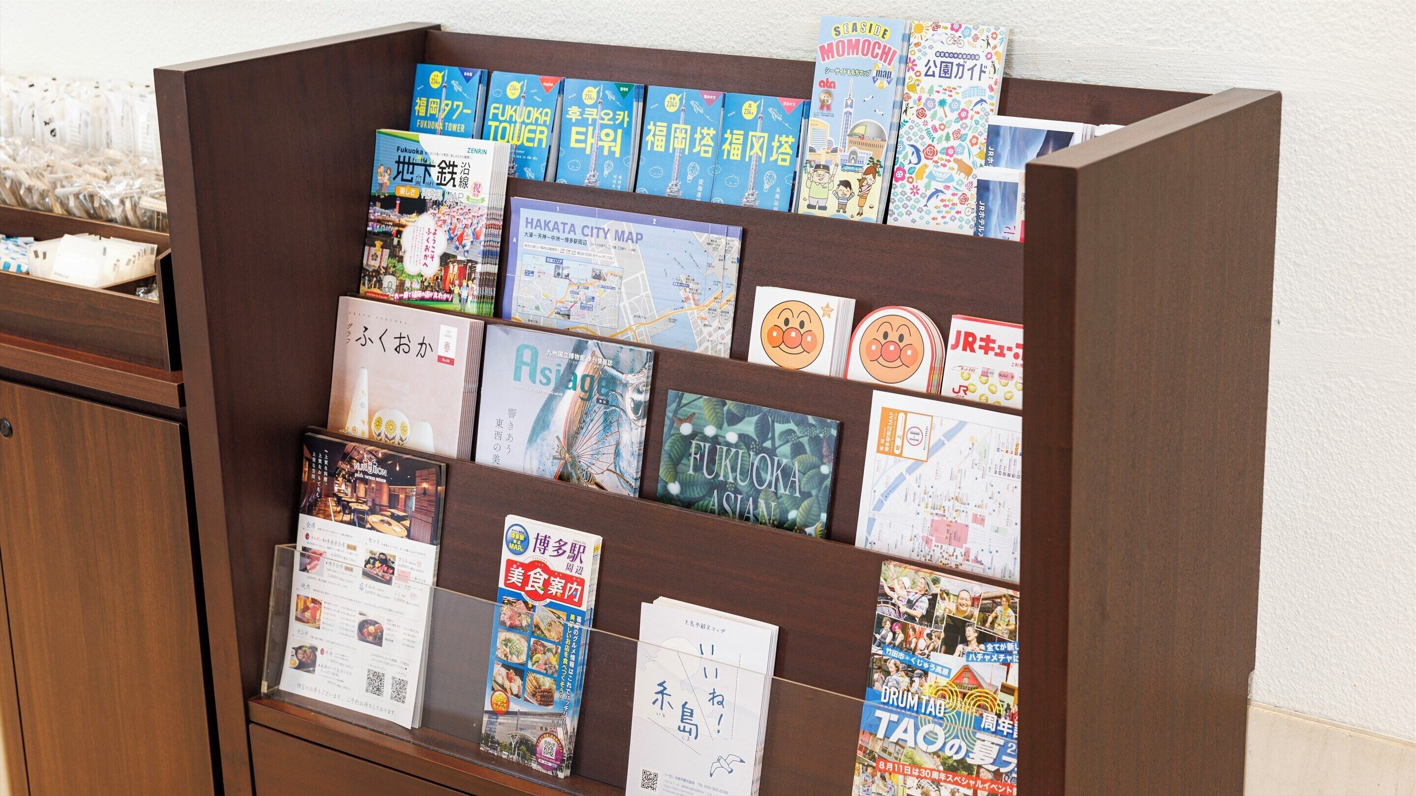 A display of various travel and informational brochures in a wooden cabinet.