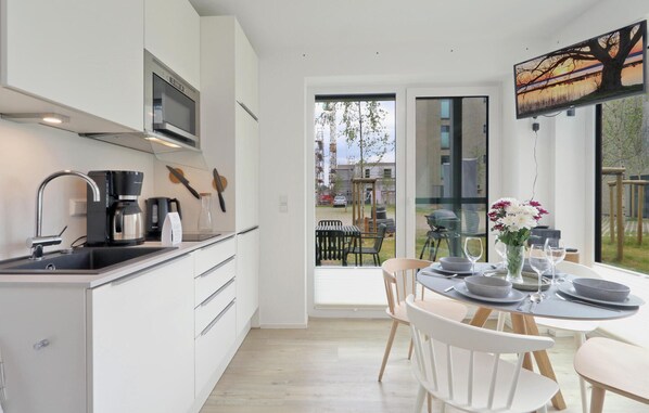 Fridge, stovetop, dishwasher, coffee/tea maker