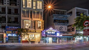 A modern hotel with multiple floors, large windows, and a well-lit facade. - Thanh Long Hotel Bach Dang (Ho Chi Minh City)