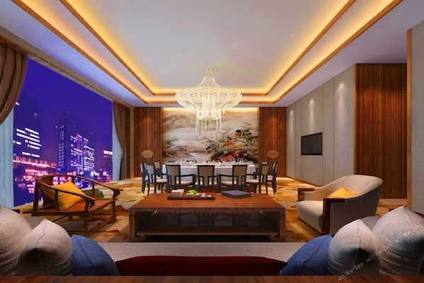 A modern living room with a dining area, a chandelier, and a cityscape view through large windows.