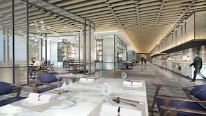 A modern interior with a long dining area, glass partitions, and a high ceiling with wooden beams. - Oriental Ginza International Hotel (Dongguan)