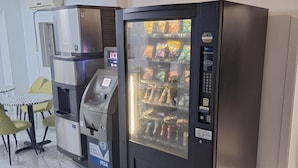 A vending machine with a payment terminal and a beverage dispenser. - Super 8 by Wyndham Montreal (Montreal)
