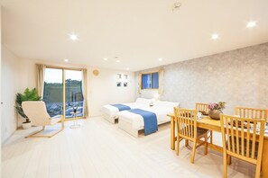 A modern hotel room with a balcony, a dining area, and a large window. - E-horizon Resort Condominium Nago C (Nago)