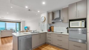A modern kitchen with stainless steel appliances, a dishwasher, and a microwave. - Sea Star - Aldinga Beach - C21 SouthCoast Holidays (Aldinga Beach)
