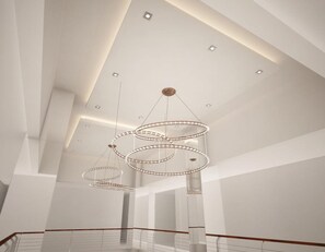 A spacious interior with a modern chandelier and recessed lighting. - Hotel 88 Banjarmasin by WH (Banjarmasin)