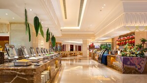 A buffet area with multiple food stations, a marble counter, and a seating area with tables and chairs. - Oriental Ventura (Lishui)