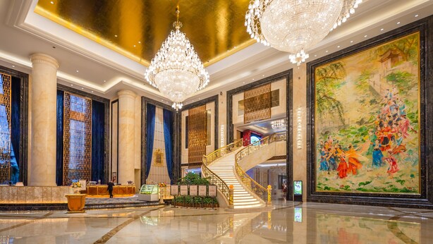 A luxurious lobby with a grand staircase, chandeliers, and a large mural. - Oriental Ventura (Lishui)