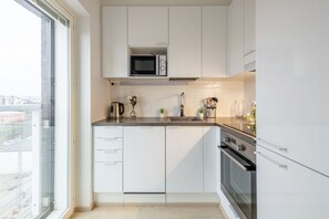 Studio, City View | Private kitchen | Full-size fridge, microwave, oven, stovetop - WeHost Malagankatu 2 (Helsinki)