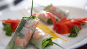 A plate of Vietnamese spring rolls with shrimp, lettuce, and tomato slices. - Hoi An Coco Viet Homestay (Da Nang)