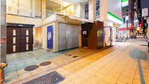 A street view with a closed shop, a fire hydrant, and a pedestrian crossing. - Lumiere Higashi Shinsaibashi St27 (Osaka)