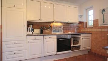 Fridge, toaster, cookware/dishes/utensils, dining tables