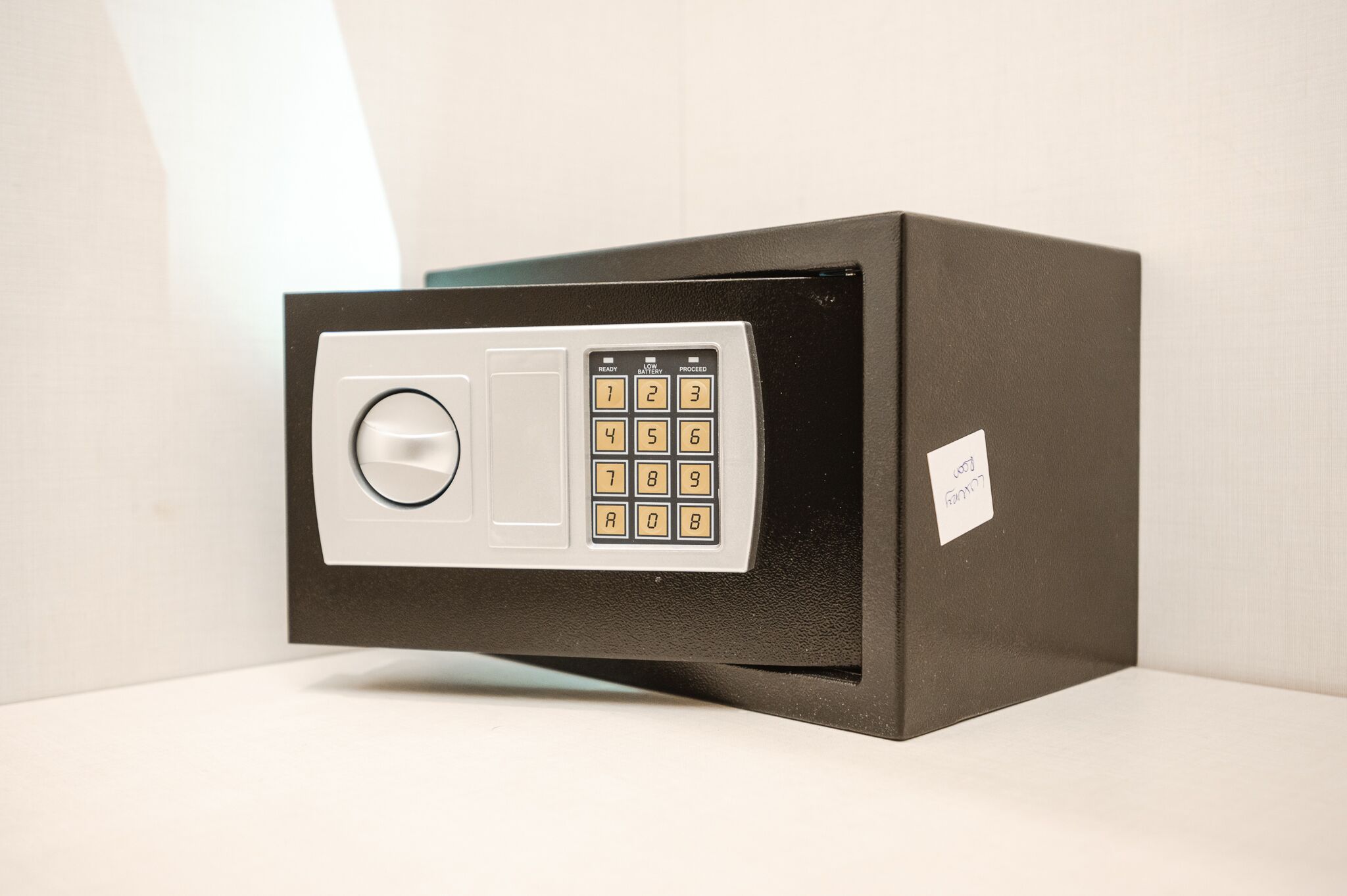 A safe with a keypad and a dial lock.