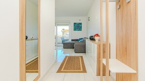 A modern living room with a sofa, a coffee table, and a wooden cabinet. - Apartment Andreja (Vir)