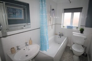 Bathtub, hair dryer, towels, soap