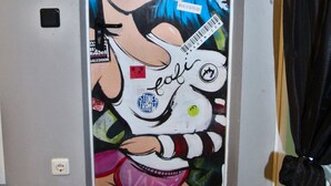 A door with a colorful mural featuring a cartoon character. - Mixie Home (Hanau)