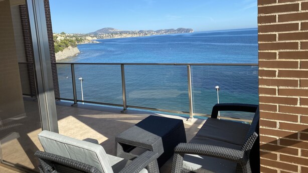 A balcony with wicker furniture overlooking a coastal view. - Mediterranean Santa Clara 4A (Calpe)