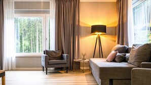 A modern living room with a sofa, armchair, and a floor lamp. - stuub langenbach (Titisee-Neustadt)