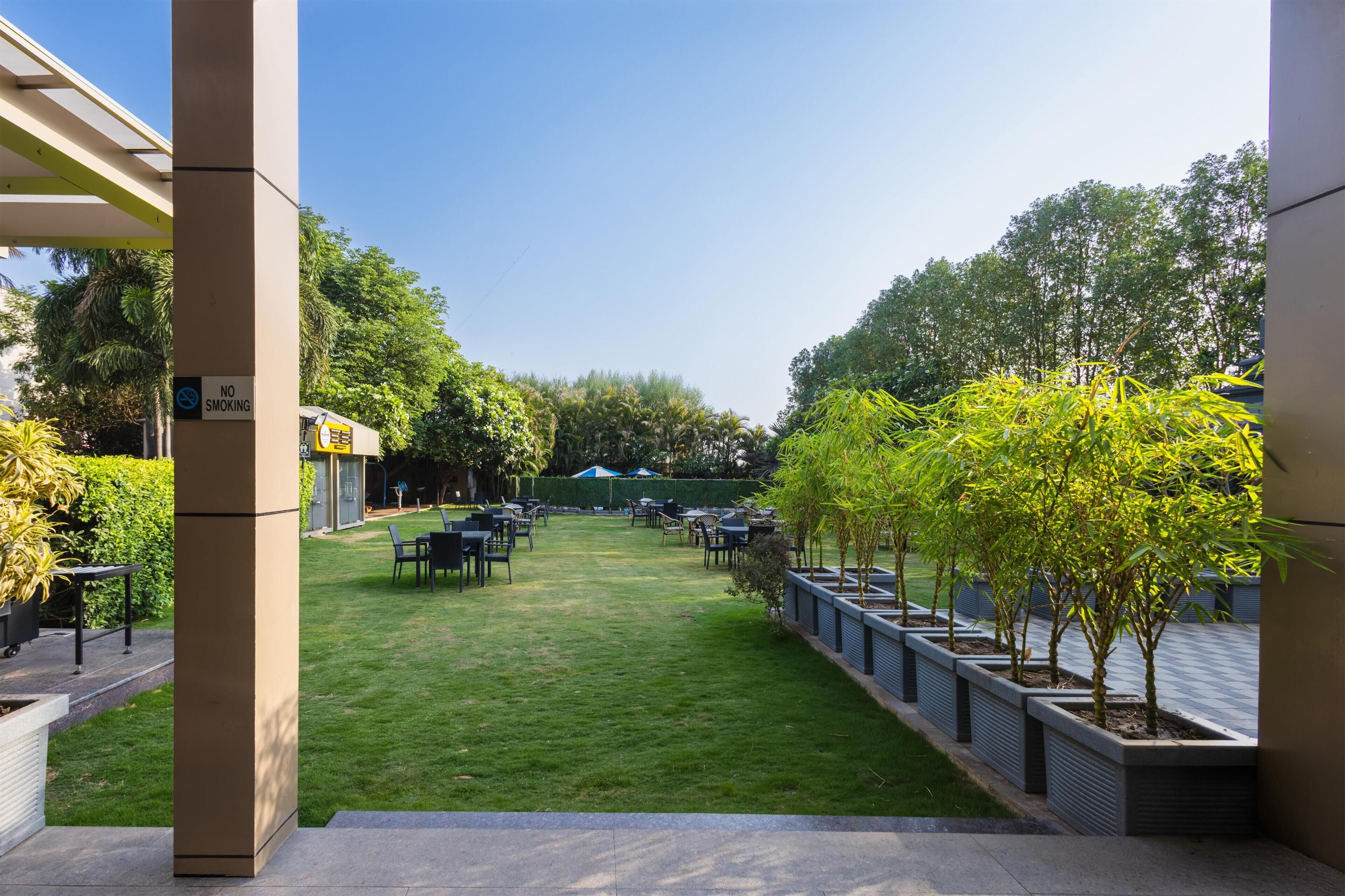 A courtyard with outdoor seating, a 'NO SMOKING' sign, and a clear sky.