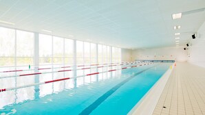 An indoor swimming pool with clear lanes, large windows, and a tiled floor. - Sportpark Rabenberg (Breitenbrunn/Erzgeb.)