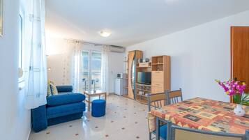 Apartment, Sea View (A4) | Living area | Flat-screen TV