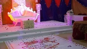 A stage with a white sofa, red curtains, and a floral backdrop. - Big Pepper Apartment (Abuja)