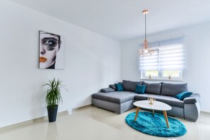 Apartment, 1 Bedroom, Sea View (A1) | Living area | Flat-screen TV