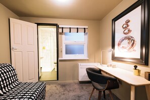 A compact room with a desk, chair, and a door leading to a bathroom. -  The Warwick by Nestor (London)