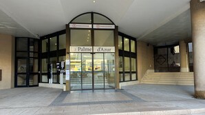 The entrance to La Palme d'Azur with glass doors and a sign indicating Pierre Vacances. - Cannes holiday apartment 606 with balcony, sea view, A/C and parking (Provence-Alpes-Côte-D’Azur)