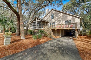 A two-story house with a covered porch and a staircase leading to the upper level. - 76 Dune Lane | Walk to Beach | Dog Friendly (Hilton Head Island)