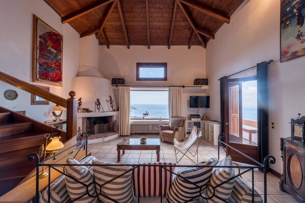 Villa | Living area | TV, fireplace