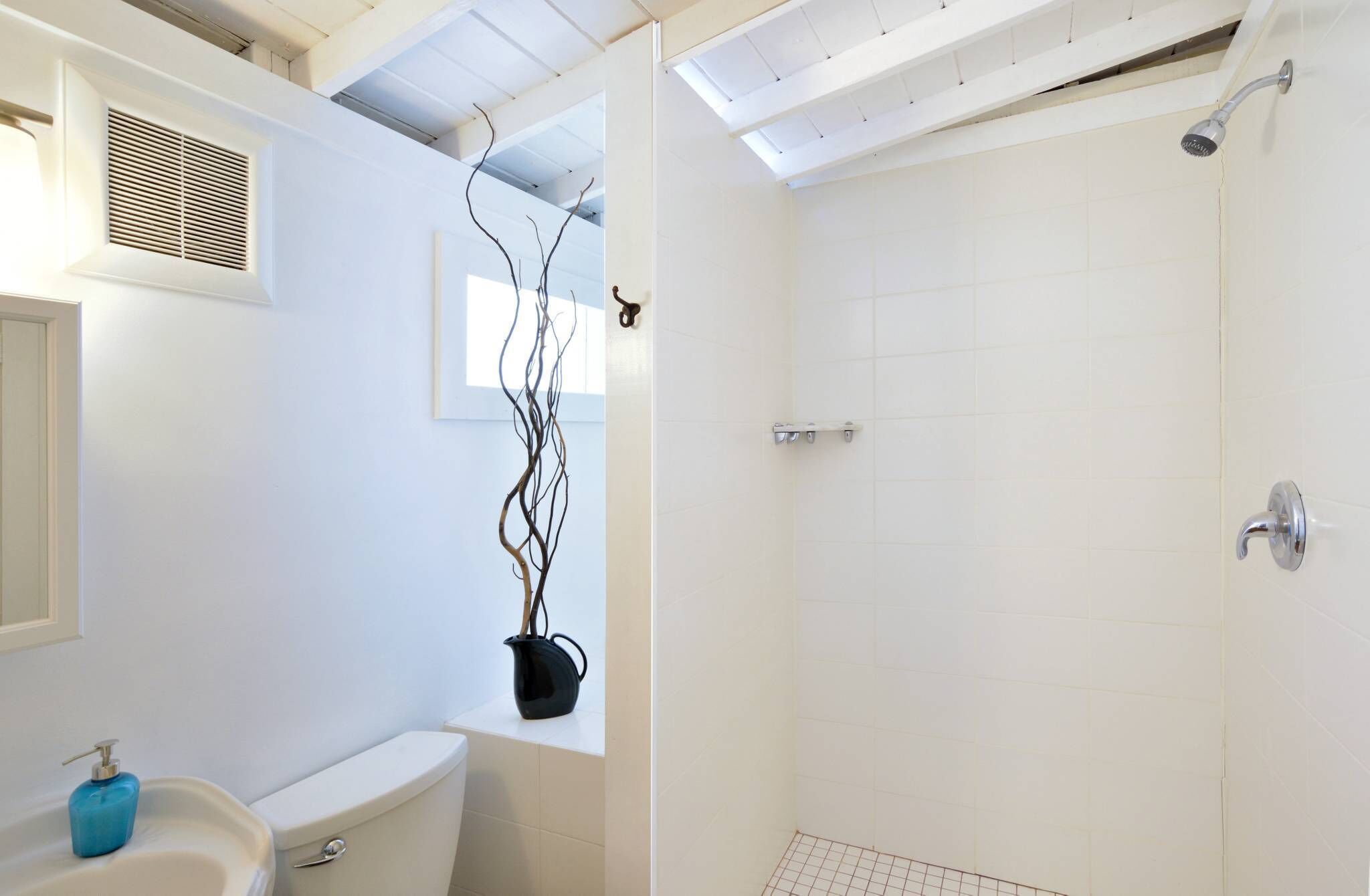 A bathroom with a toilet, sink, and shower.