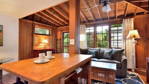 A wooden interior with a dining table, a sofa, and a coffee table. - ~ SOLARIS PAIR-A-DISE ~ A garden lover’s dream on a quiet Key West lane. (Key West)