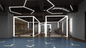 A modern gym with treadmills arranged in rows, geometric lighting fixtures, and a blue floor with directional arrows. - Holiday Inn Express Liaocheng Chiping by IHG (Liaocheng)