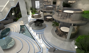Un intérieur moderne doté de plusieurs espaces de détente, d’une piscine centrale et d’un escalier.