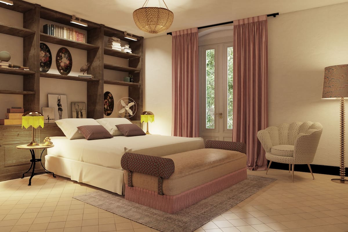 A spacious bedroom with a large bed, a wooden bookshelf, a standing fan, and a chair.