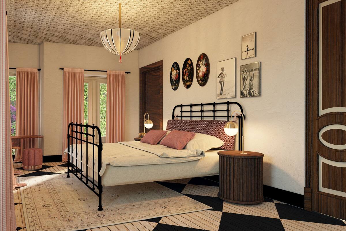 A bedroom with a bed, curtains, a patterned rug, a round wooden side table, and wall art.