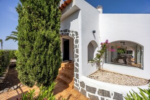 A modern house with a stone exterior, a patio with steps, and a glass door leading to an interior space. - Casa Bodil, villa for 8 with private pool (Praia do Carvoeiro)