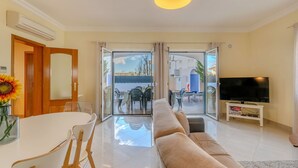 A modern living room with a sofa, TV, and dining area. - Stunning private villa for 11 people with private pool, A/C, WIFI, TV and terrace (Galé)
