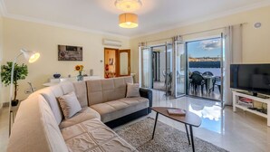 A modern living room with a beige sofa, a coffee table, and a TV on a stand. - Stunning private villa for 11 people with private pool, A/C, WIFI, TV and terrace (Galé)