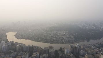 A cityscape with a river in the center, surrounded by dense urban buildings.
