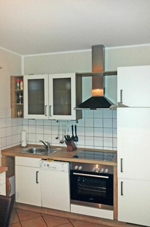 Enjoy cooking in this well-equipped kitchen with a dishwasher, stainless steel oven, and range hood.